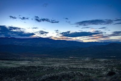 Scenic view of mountains against sky at sunset
