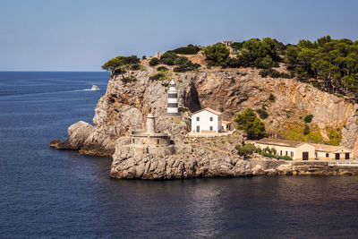 Building by sea against clear sky