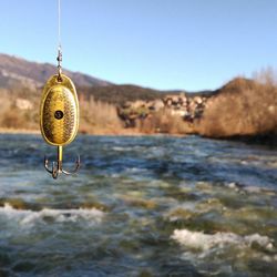 Close-up of water hanging against clear sky