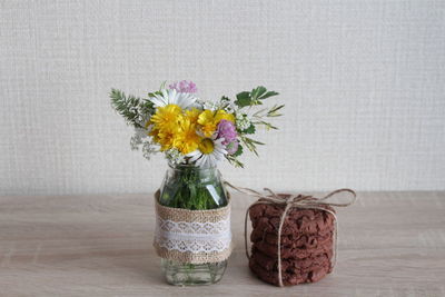 Close-up of flower vase against white wall