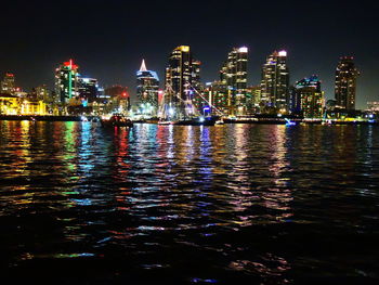 Illuminated city at waterfront