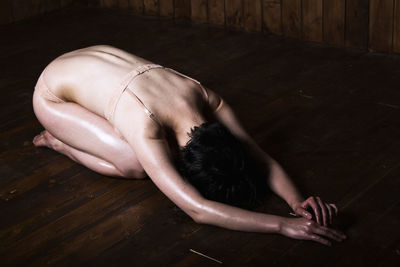 High angle view of woman lying on floor