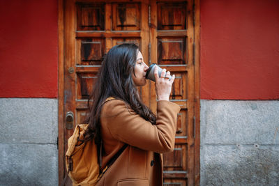 Midsection of woman holding drink