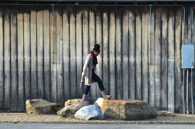 Full length of man standing against wall