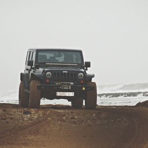 Vintage car on beach against clear sky