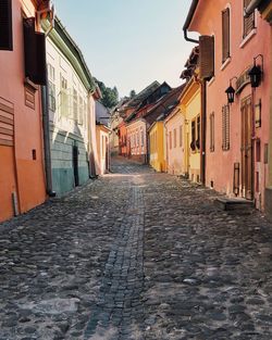 Alley amidst buildings against sky