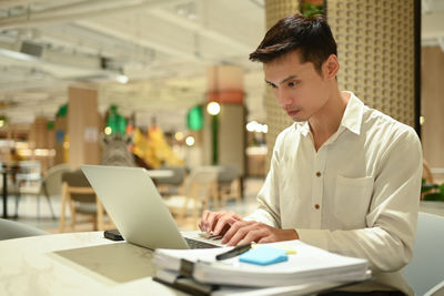 Businesswoman using laptop at office