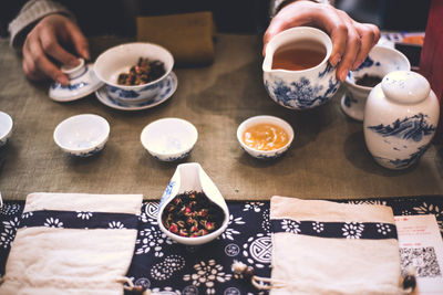 Cropped image of woman making herbal tea at home