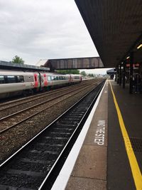 Train at railroad station against sky