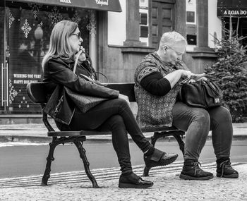Full length of young woman sitting on seat