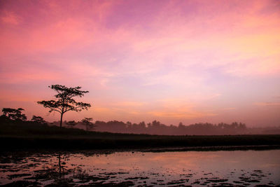 Scenic view of lake against sky during sunset