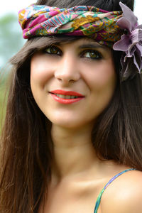 Close-up of smiling woman looking away while wearing headband