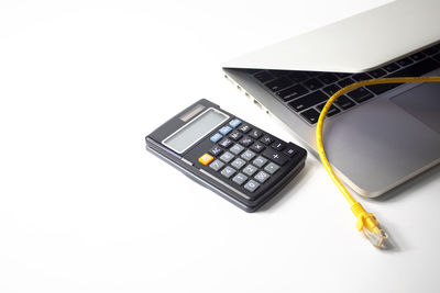 High angle view of laptop on table against white background