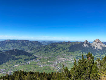 Scenic view of mountains against blue sky