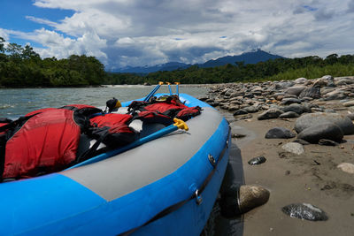 View of boats in calm lake against sky