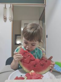 Boy holding ice cream at home