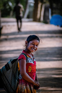 Portrait of cute girl standing on street