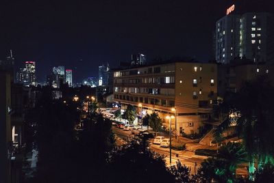 Illuminated cityscape against sky at night