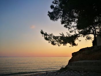 Scenic view of sea against clear sky at sunset