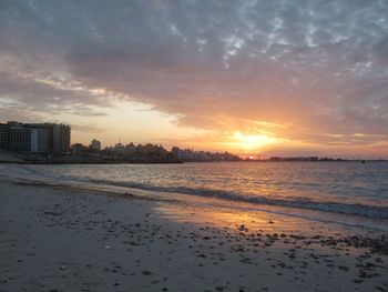 Scenic view of beach against sky during sunset