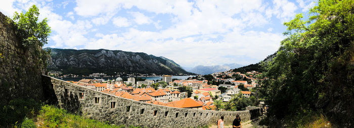 View of town against cloudy sky