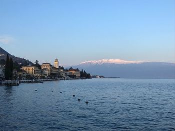 Scenic view of sea by buildings against sky