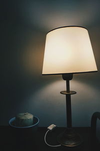 Close-up of illuminated lamp on table at home