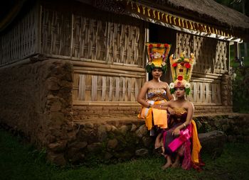 Balineese rejang dancer sitting on old house