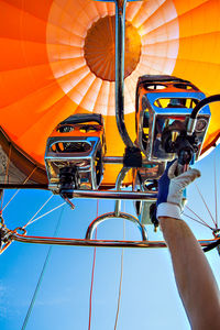 Low angle view of man standing in hot air balloon