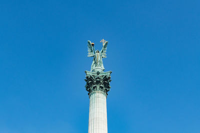 Low angle view of statue against clear blue sky