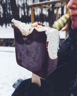 Close-up of hand holding ice cream