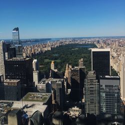 Urban skyline against blue sky