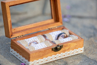 High angle view of engagement rings on box on concrete