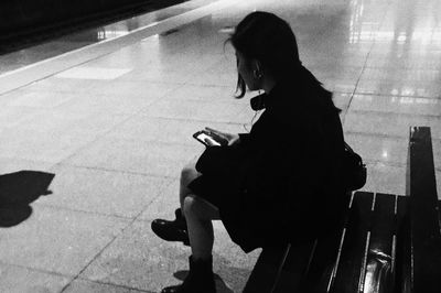 Side view of woman using mobile phone