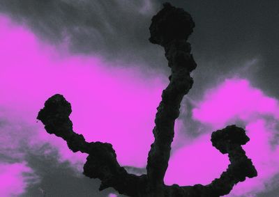 Silhouette man against pink sky at night