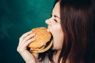 Woman eating hamburger 