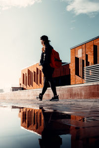 A woman in a puddle reflection