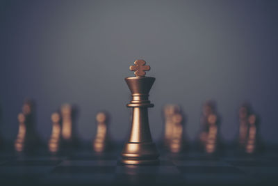 Close-up of chess pieces against gray background