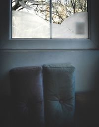 Empty chair against window at home