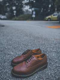 Close-up of shoes on the road