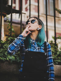 Low angle view of hipster smoking cigarette