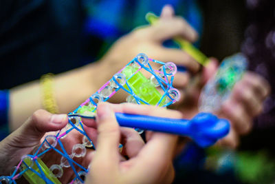 Cropped hands of child playing with toys