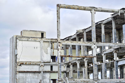 Low angle view of abandoned building against sky