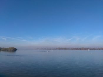 Scenic view of lake against blue sky