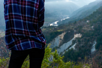 Rear view of woman standing on mountain