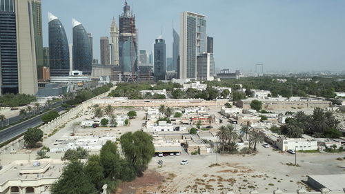 Aerial view of buildings in city against sky