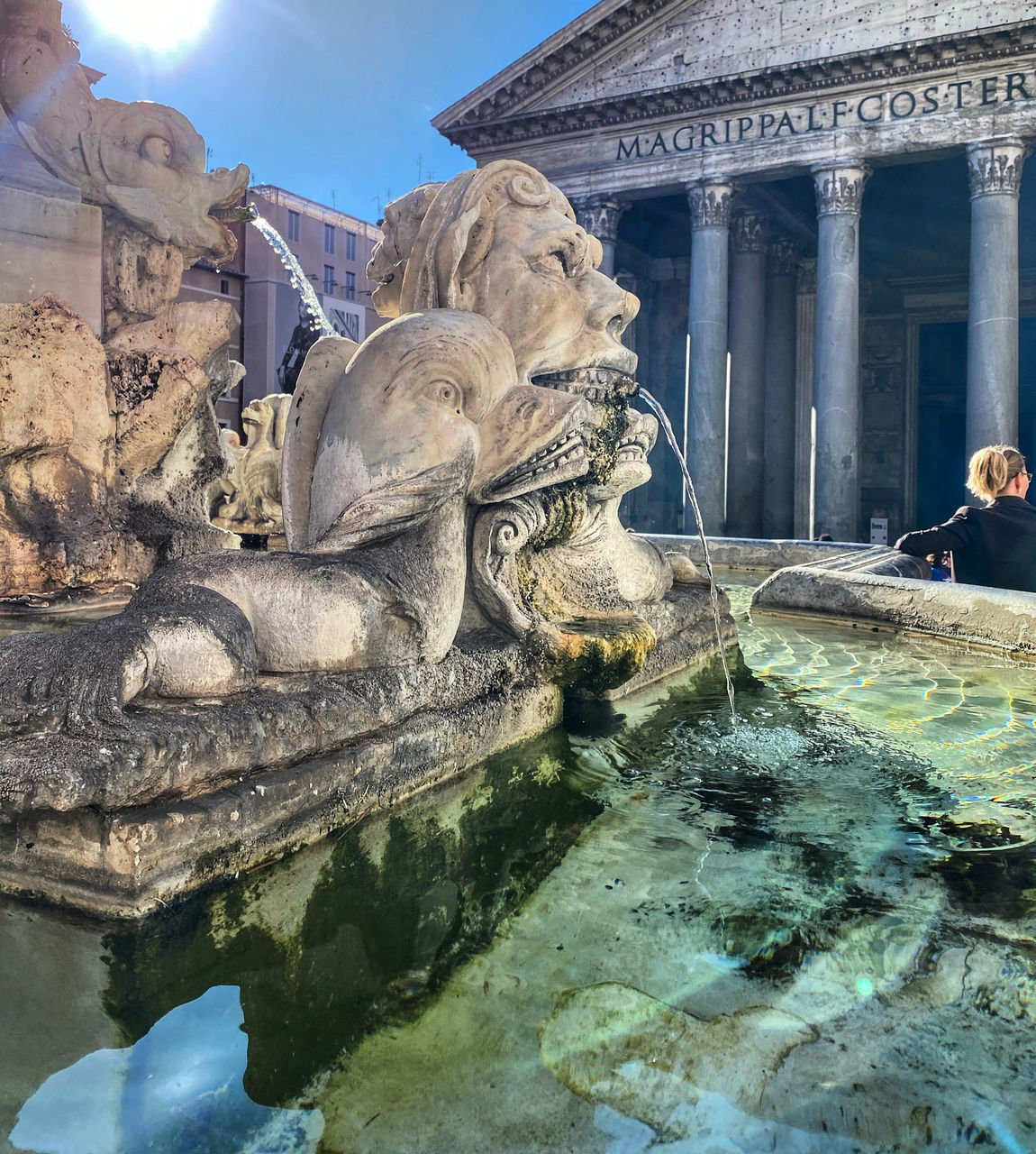 STATUE OF POND AGAINST BUILDINGS