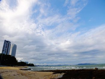 View of beach against cloudy sky