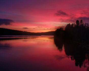 Scenic view of lake against romantic sky at sunset