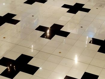 Reflection of modern building on tiled floor